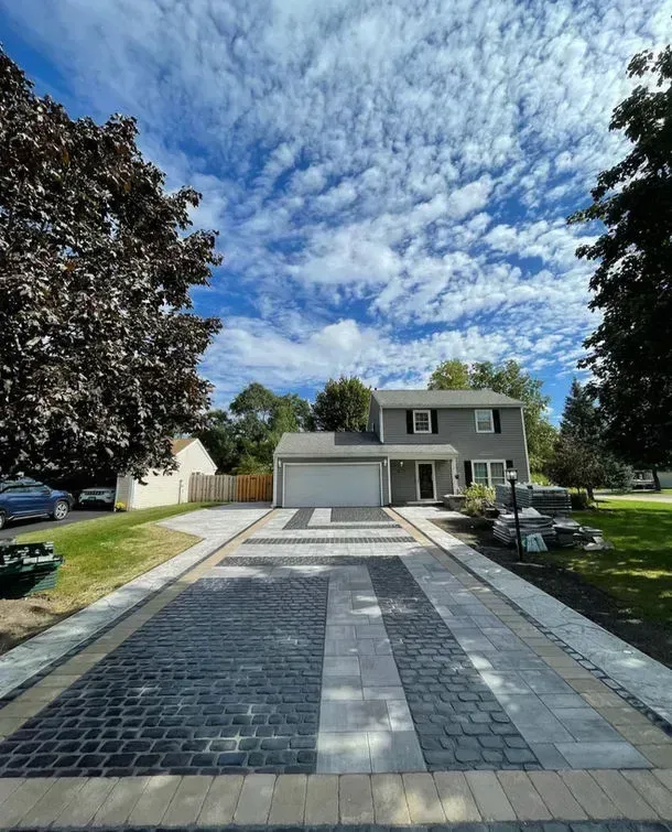 Custom geometric paver driveway with contrasting border details
