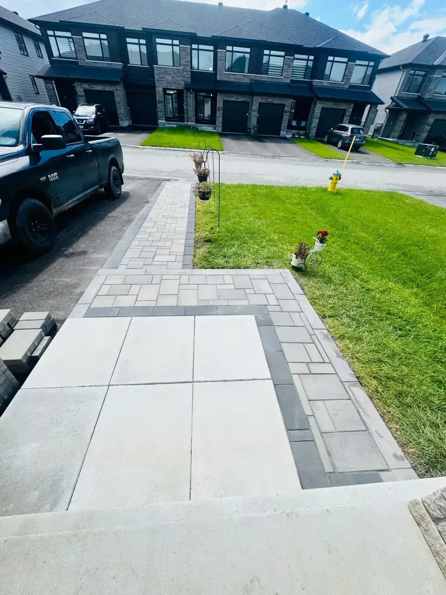 Finished stone walkway with a contrasting border at a home entrance