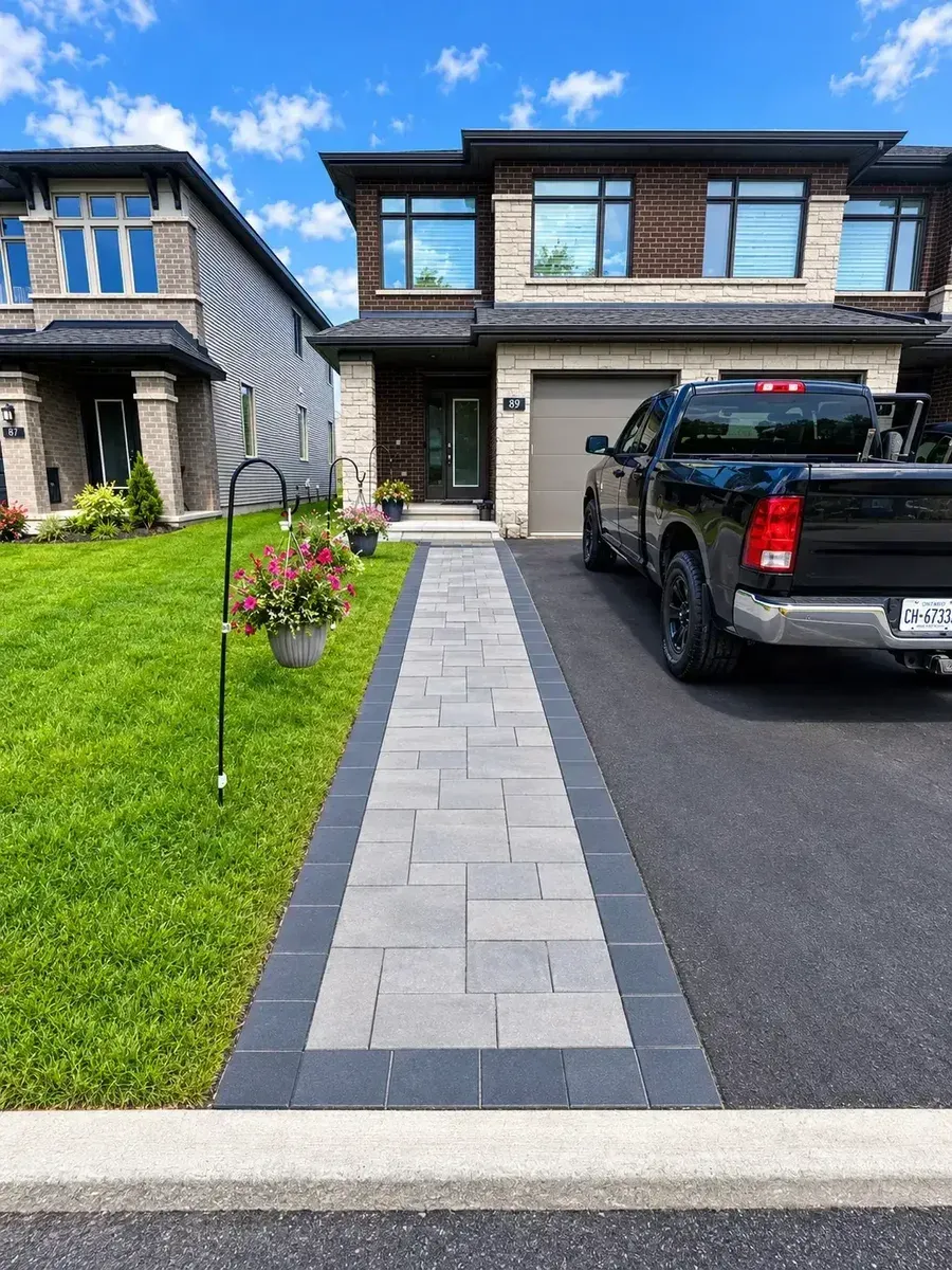 A finished walkway leading through a landscaped residential yard
